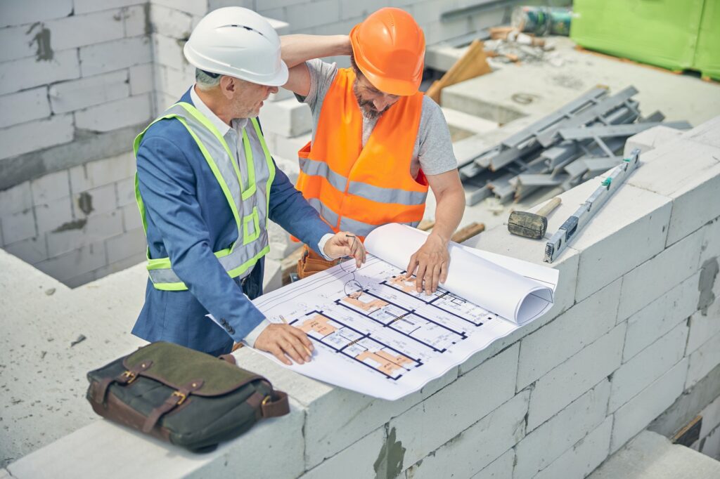 Civil engineer looking at a puzzled male worker
